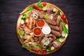 Assorted grilled meat and vegetables on rustic table