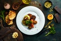 Assorted grilled vegetables: mushrooms, peppers, paprika, zucchini and eggplant on a plate. Royalty Free Stock Photo