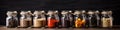 Assorted ground spices in bottles on wooden background. Royalty Free Stock Photo