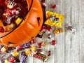 Plastic pumpkin with spilled candy Royalty Free Stock Photo