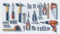 Assorted Hand Tools and Hardware Organized on Pegboard in Workshop Royalty Free Stock Photo