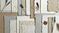 Assorted handmade paper sheets in neutral tones are arranged overlapping Royalty Free Stock Photo