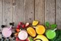 Assorted healthy smoothies, top view bottom border against a wood background with copy space Royalty Free Stock Photo