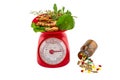 Assorted of herbal in red weight scale and colorful pills in bl