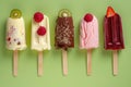 Assorted ice pops with fruits on a green background. Royalty Free Stock Photo