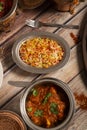Assorted Indian dishes of rice and curry on wooden background. Top view. Vertical picture