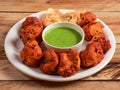 Assorted indian food Chicken Tikka kebab served on rustic wooden background. Dishes and appetizers of indian cuisine, selective Royalty Free Stock Photo