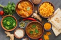 Assorted Indian food on a dark rustic background. Traditional Indian dish Chicken tikka masala, palak paneer, saffron rice, lentil