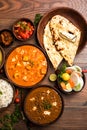 Indian lunch or dinner items like dal, paneer butter masala, roti, rice, salad Royalty Free Stock Photo