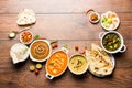 Indian lunch or dinner items like dal, paneer butter masala, roti, rice, salad Royalty Free Stock Photo