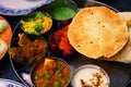 Assorted Indian food set in tray, tanduri chicken, naan bread, yoghurt, traditional curry, roti