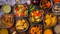 Assorted indian food set on wooden background. Dishes and appetisers of indeed cuisine, rice, lentils, paneer, samosa, spices.