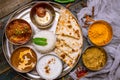 Assorted indian food set on wooden background. Dishes and appetisers of indeed cuisine, rice, lentils, paneer, samosa, spices, mas Royalty Free Stock Photo