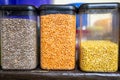 assorted indian lentils and pulses stored in transparent plastic containers on shelf Royalty Free Stock Photo