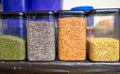 assorted indian lentils and pulses stored in transparent plastic containers on shelf Royalty Free Stock Photo