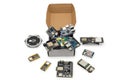 Assorted IoT and embedded development boards scattered from open box Royalty Free Stock Photo