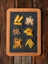 Assorted Italian pasta on blackboard