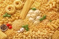 Assorted Italian Pasta Varieties Background With Fresh Basil Garlic And Tomatoes Royalty Free Stock Photo
