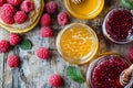 Assorted jams and honey with fresh raspberries on rustic wooden table Royalty Free Stock Photo