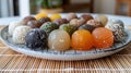 Assorted japanese mochi in a variety of flavors on minimalist plate with bamboo mat Royalty Free Stock Photo