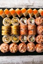 Assorted japanese sushi rolls on black background