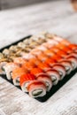 Assorted japanese sushi rolls on black background