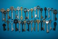 Assorted keys on blue background, safeguarding homes with unique styles