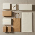 Assorted kraft paper and cardboard packaging items are arranged on a textured beige Royalty Free Stock Photo