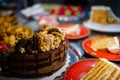 Assorted large pieces of different cakes: chocolate, raspberries, strawberries, nuts, blueberries. Pieces of cakes on a Royalty Free Stock Photo