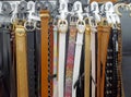 Assorted leather belts hanging vertically on display racks. Royalty Free Stock Photo