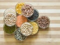 Assorted lentils and legumes in glass bowls, ona chopping board Royalty Free Stock Photo