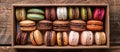 Assorted macarons in a box on rustic wood