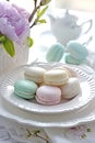 Assorted macarons on a plate with a peony, high tea elegance. AI Generated