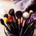 Assorted makeup brushes with copy space, beauty artist workspace, bunch of different brushes on blurred background