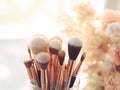 Assorted makeup brushes with copy space, beauty artist workspace, bunch of different brushes on blurred background