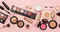 Assorted makeup products arranged on a pink background with glitter Royalty Free Stock Photo