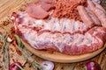 Assorted meat. Arrange the raw pork ribs, minced meat, sausages, and carbonate on a round cutting board. Seasonings for cooking Royalty Free Stock Photo