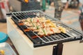 Assorted meat from chicken and pork and various vegetables on barbecue grill cooked.