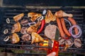 Assorted meat from chicken and pork and various vegetables on barbecue grill cooked for summer family dinner Royalty Free Stock Photo