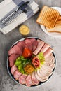 Assorted meat delicacies in a plate on the table Royalty Free Stock Photo