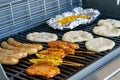 Assorted meat grilling over the hot fire on a portable barbecue with steak, sausage, kebabs, chicken , spare ribs and Royalty Free Stock Photo