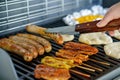Assorted meat grilling over the hot fire on a portable barbecue with steak, sausage, kebabs, chicken , spare ribs and Royalty Free Stock Photo