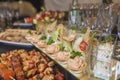 Assorted meat on a plate close up. Different types of meat and potatoes in a heap. Appetizer on a large plate with Royalty Free Stock Photo