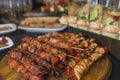 Assorted meat on a plate close up. Different types of meat and potatoes in a heap. Appetizer on a large plate with Royalty Free Stock Photo