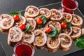 Assorted meat, stuffed chicken rolls, meat rolls stuffed with mushrooms, cranberries and dried apricots on black shale background Royalty Free Stock Photo