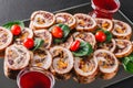 Assorted meat, stuffed chicken rolls, meat rolls stuffed with mushrooms, cranberries and dried apricots on black shale background Royalty Free Stock Photo