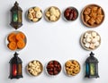 Assorted Middle Eastern Sweets with Dates Apricots and Decorative Lanterns on White Royalty Free Stock Photo