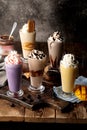 Assorted milk shakes with banana, mango, cream, ice cream, chocolate, berry served in glass side view of healthy drink