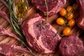 Assorted minced meat ingredients - rack of calf, ribeye, rack of lamb, with garlic, onions, red and yellow tomatoes, red pepper