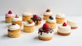 Assorted mini cakes with fresh berries and chocolate drizzle, arranged for a delightful dessert display. Generative AI Royalty Free Stock Photo